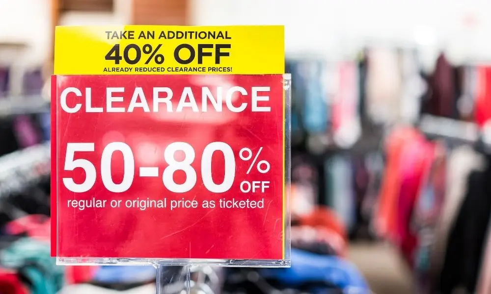 Clearance merchandise signage showing 40% off and 50-80% discount pricing for retail arbitrage opportunities